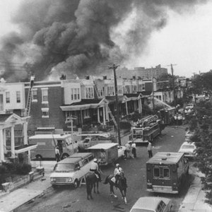 The Move House burning after the bomb was dropped on the roof.
